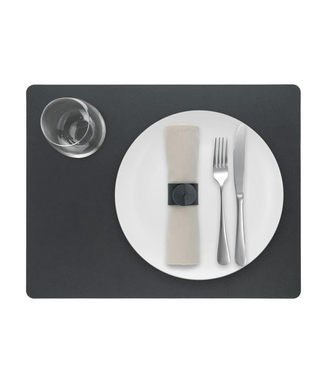 Dark grey rectangular Finesse placemat with a white plate, cutlery and glass viewed from above