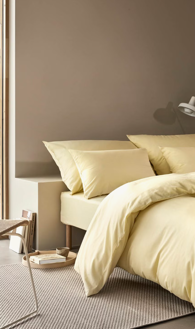 Yellow Høie Harmoni duvet cover set on a made bed in a bedroom