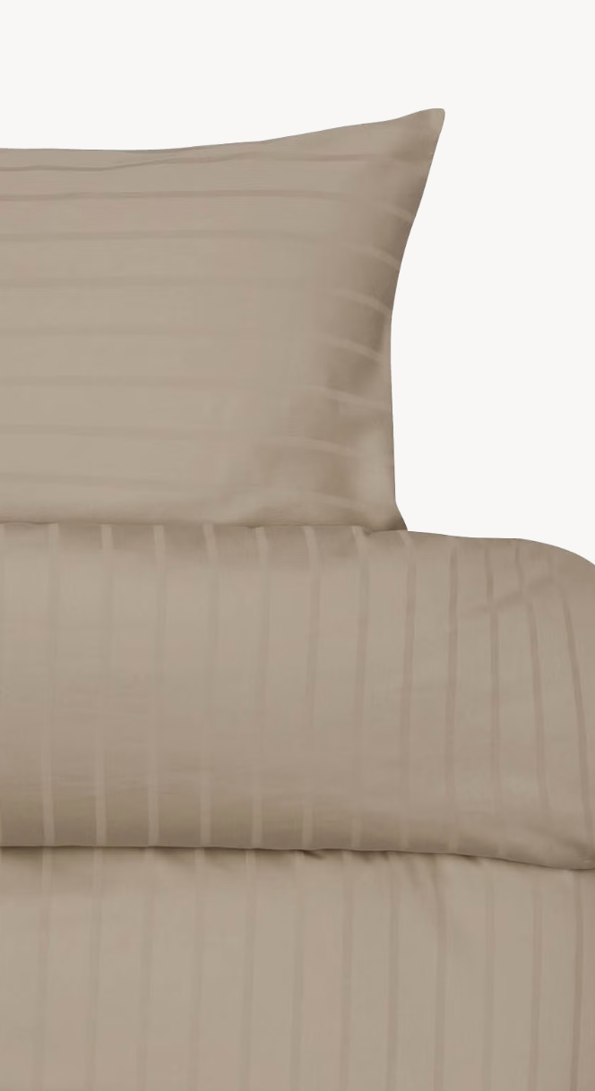 Light brown Høie Milano duvet cover set showing the pillowcase and turned-down top edge; subtle tonal stripes