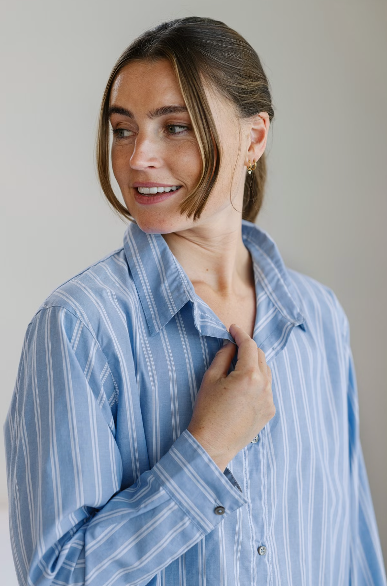 Collar, buttons and blue and white stripes of a Høie Sana pyjama shirt worn by a person