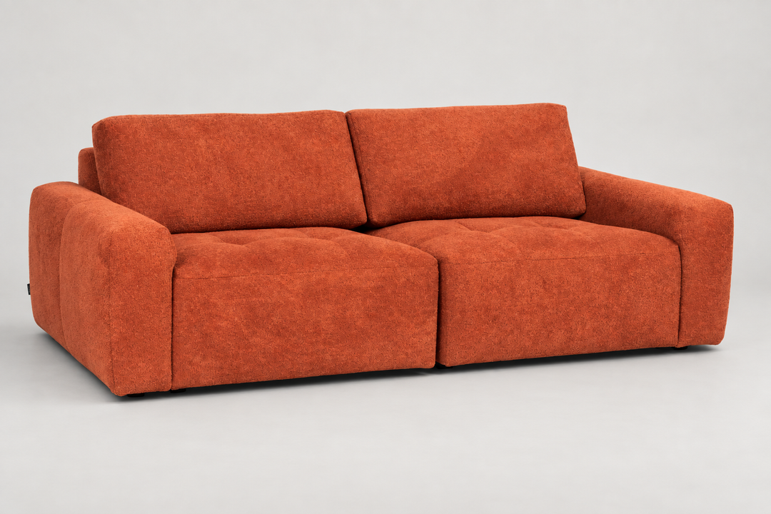 Angled view of an orange-red Hotel Luxus Madele 1 sofa with two seat cushions, two back cushions and rounded armrests. Visualisation.