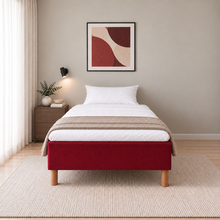 Hotel Luxus Pocket Bonnel runkosänky 140x200 cm, Vogue 7 punainen modernissa makuuhuoneessa, suoraan jalkopäästä kuvattuna. Yksi tyyny. Sisustushavainnekuva; Hotel Plus -petauspatja sisältyy hintaan, vuodevaatteet eivät.